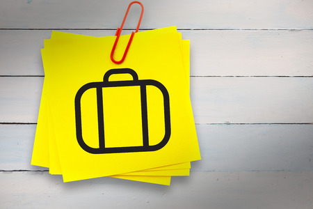 Briefcase graphic against sticky note with red paperclipの写真素材
