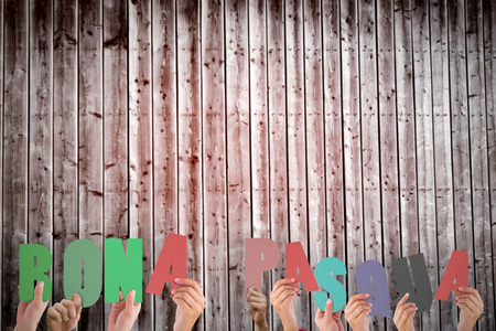 Hands holding up bona pasqua against wooden planksの写真素材