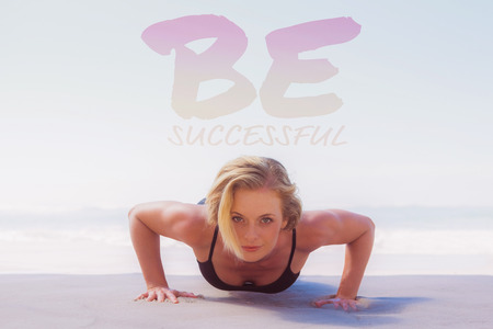 Fit blonde in plank position on the beach against be succesful