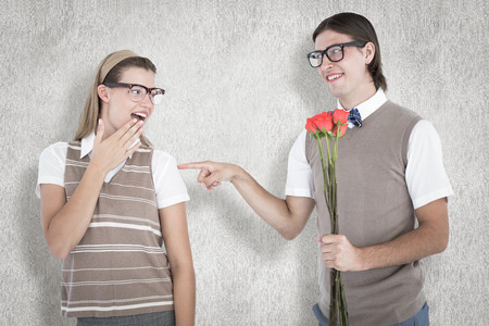 Geeky hipster offering red roses to his girlfriend  against white backgroundの写真素材