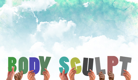 Hands holding up body scuplt against green and blue sky