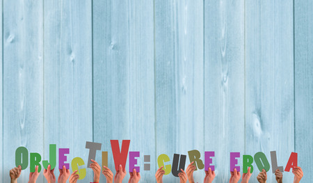 Hands holding up cure ebola against wooden planks