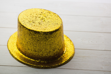 Gold party hat on wooden table