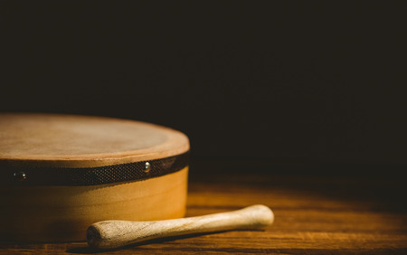 Traditional Irish bodhran and stick on wooden tableの写真素材