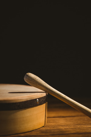 Traditional Irish bodhran and stick on wooden tableの写真素材