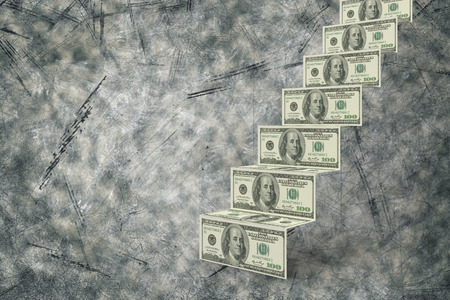 Steps of dollars against grey backgroundの写真素材