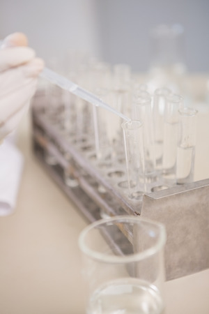 Scientist analyzing test tube in laboratoryの写真素材