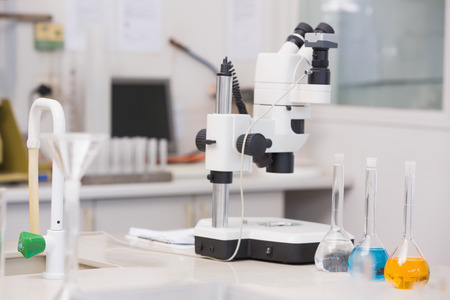 Microscope and beakers in laboratoryの写真素材