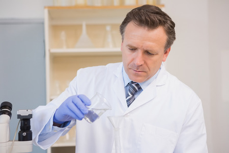 Scientist doing experimentations in flask in the laboratory