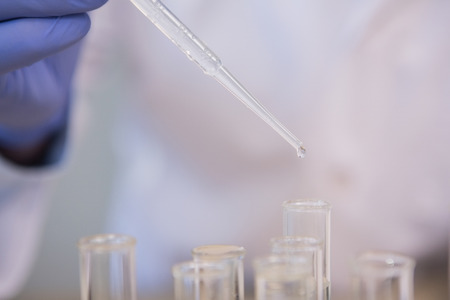 Scientist doing experimentations in tubes in the laboratory