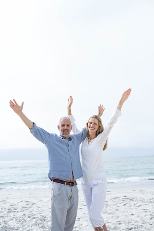 Happy couple having fun together at the beachの写真素材