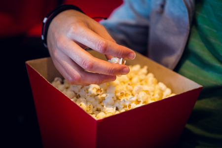 Man eating popcorn at the cinemaの写真素材