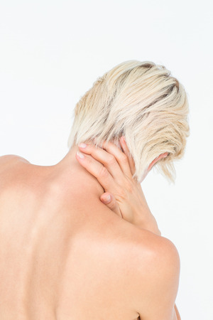 Attractive woman suffering from neck pain on white backgroundの写真素材