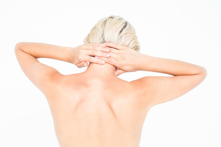 Attractive woman suffering from neck pain on white backgroundの写真素材