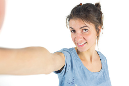 Casual brunette taking a selfie shot in studioの写真素材