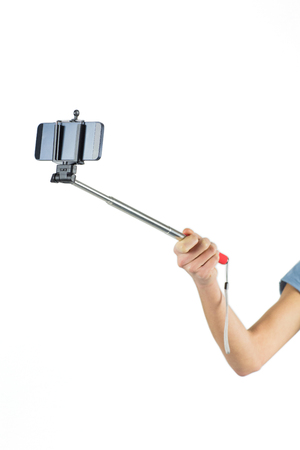 Woman taking a selfie shot in studioの写真素材