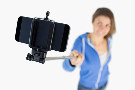 Casual brunette taking a selfie shot in studio