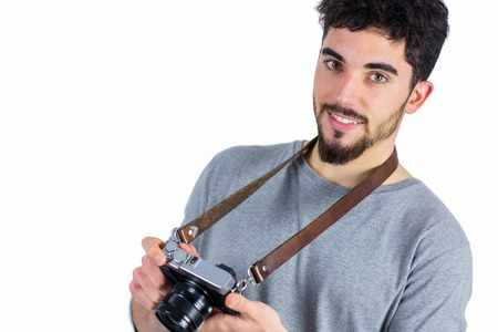 Casual man holding his camera shot in studio
