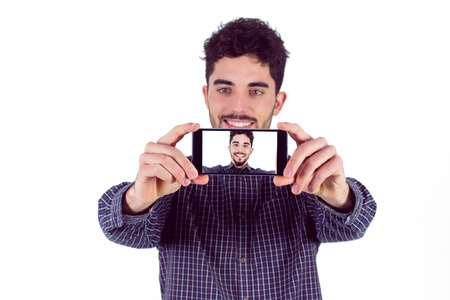Casual man taking a selfie shot in studio