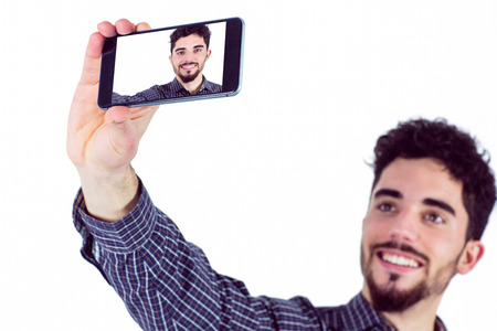Casual man taking a selfie shot in studio