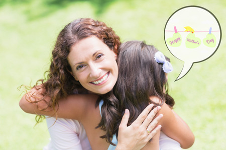 mothers day greeting against happy mother and daughter huggingの写真素材