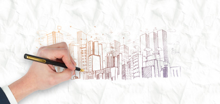 Hand holding a fountain pen against crumpled white pageの写真素材