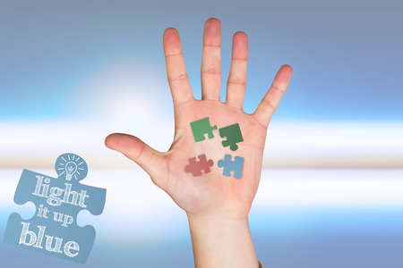 Hand with fingers spread out against blue and white skyの写真素材