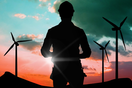 Portrait of smiling manual worker holding clipboard against blue and pink skyの写真素材