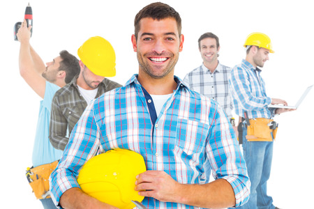 Composite image of smiling handyman holding hardhat and hammer