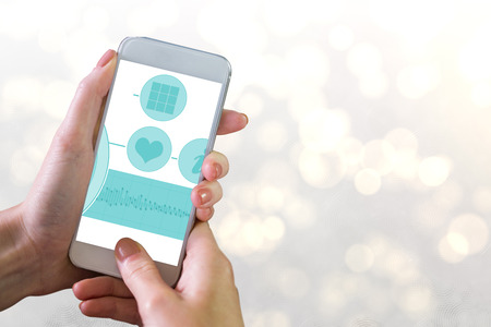 Hand holding smartphone against white light abstract design backgroundの写真素材