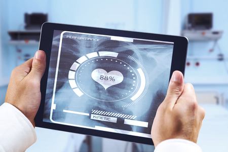 Man using tablet pc against sterile bedroomの写真素材