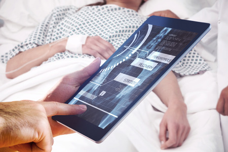 Man using tablet pc against medical interface on xrayの写真素材