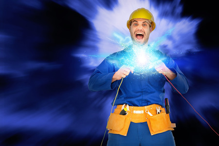 Repairman screaming while holding wires against blue sky with white cloudsの写真素材