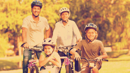 Family with their bikes in a park during the summer