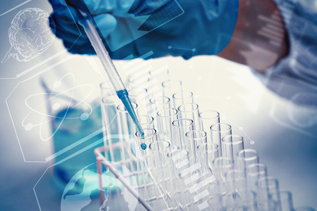 Protected hand dropping liquid in test tubes against science and medical graphicの写真素材