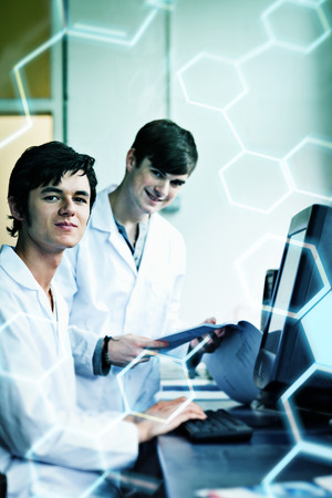 Science and medical graphic against portrait of male scientists with a monitorの写真素材