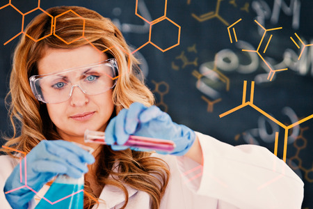 Science and medical graphic against young female scientist carrying out an experimentの写真素材