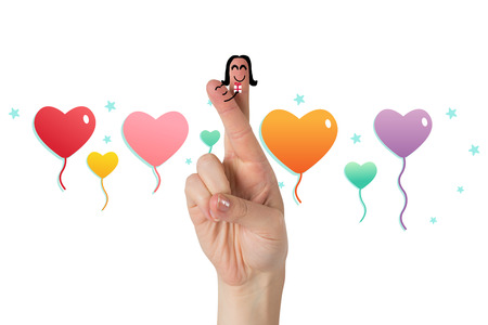 Fingers as a couple against heart balloonsの写真素材