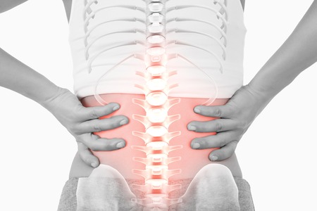 Digital composite of Highlighted spine of woman with back pain