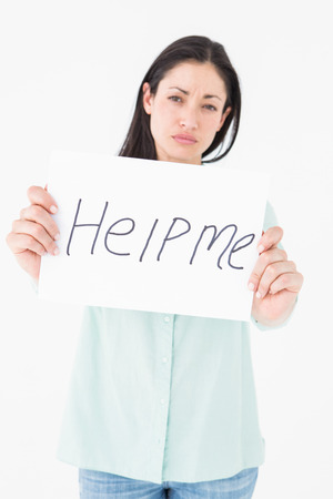 Sad woman asking for help on white backgroundの写真素材