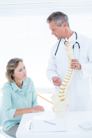 Doctor having conversation with his patient in medical officeの写真素材