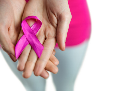 Woman with breast cancer ribbon on white backgroundの写真素材