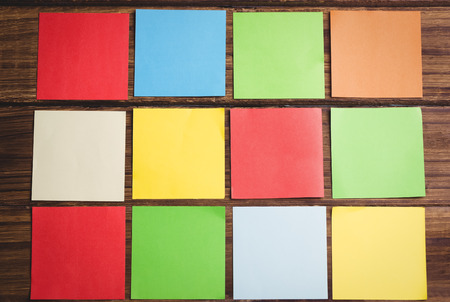 Colorful sticky post its on wooden background