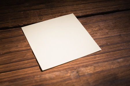 White post it on wooden background