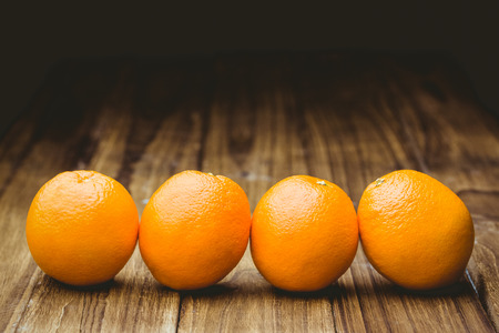 Fresh oranges on wooden backgroundの写真素材