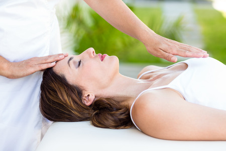 Calm woman receiving reiki treatment in the health spaの写真素材