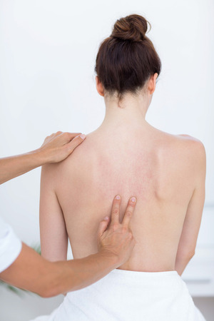 Physiotherapist doing back massage in medical officeの写真素材
