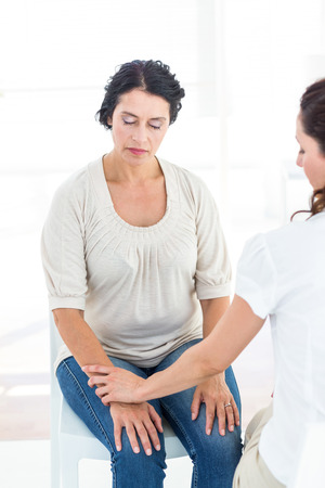 Hypnotized woman with her therapist on white backgroundの写真素材