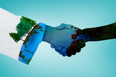 Extreme closeup of a doctor and patient shaking hands against blue vignette backgroundの写真素材