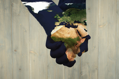 Cute couple holding hands in the park against wooden planksの写真素材